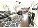 Cozy living room boasts fireplace, dark wood floors, and an open floorplan to kitchen and dining area at 2101 Adams Acres Dr, Lawrenceville, GA 30043