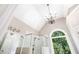 Bright bathroom featuring a glass enclosed shower and large arched window, chandelier, and modern fixtures at 226 Crescent Moon Way, Canton, GA 30114