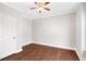 Simple bedroom design featuring hardwood floors, neutral walls, and a ceiling fan at 226 Crescent Moon Way, Canton, GA 30114