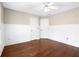 Bedroom with hardwood floors, wainscoting, ceiling fan, and two doors, offering versatility and comfort at 226 Crescent Moon Way, Canton, GA 30114