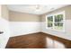 Bedroom with hardwood floors, neutral walls, wainscoting, ceiling fan, and a window overlooking the lawn at 226 Crescent Moon Way, Canton, GA 30114