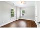 Comfortable bedroom with hardwood floors, natural light, and neutral walls at 226 Crescent Moon Way, Canton, GA 30114