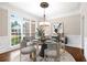 Elegant dining room featuring a modern chandelier, large windows, and stylish decor at 226 Crescent Moon Way, Canton, GA 30114