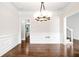 Formal dining room with wainscoting, hardwood floors, and elegant chandelier at 226 Crescent Moon Way, Canton, GA 30114