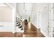Bright foyer with hardwood floors, staircase, and doorway leading to the living room with fireplace at 226 Crescent Moon Way, Canton, GA 30114