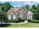 Beautiful brick home with manicured lawn and lush landscaping at 226 Crescent Moon Way, Canton, GA 30114