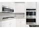 Modern kitchen featuring stainless steel appliances, gas range, and stylish backsplash at 226 Crescent Moon Way, Canton, GA 30114