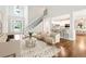 Bright, open living room with hardwood floors and staircase to the second floor at 226 Crescent Moon Way, Canton, GA 30114