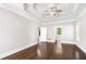 Main bedroom with hardwood floors, tray ceiling, and entry to the main bathroom at 226 Crescent Moon Way, Canton, GA 30114