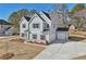 Two-story home with a side entry garage on a large lot with a new driveway, landscaping and covered entry at 3614 Squires Park Ln, Loganville, GA 30052