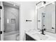Modern bathroom with sleek black fixtures, marble countertop, and striking tile in the shower at 907 Oakhill Sw Ave, Atlanta, GA 30310