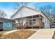 Charming bungalow-style house with a welcoming front porch and modern design elements at 907 Oakhill Sw Ave, Atlanta, GA 30310