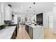 Open-concept kitchen featuring quartz countertops, a large island, and seamless transition to the living area at 907 Oakhill Sw Ave, Atlanta, GA 30310