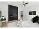 Modern bedroom with black accent wall, fireplace, and neutral decor at 907 Oakhill Sw Ave, Atlanta, GA 30310