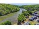 An aerial view showcasing the complex layout, set among lush trees and a river at 1119 Riverbend Club Se Dr, Atlanta, GA 30339