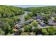 An aerial view showcasing the complex layout, set among lush trees and a river at 1119 Riverbend Club Se Dr, Atlanta, GA 30339