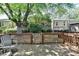 View of an elevated back deck with seating overlooking the complex green space at 1119 Riverbend Club Se Dr, Atlanta, GA 30339