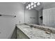 Bathroom featuring a granite countertop with a white cabinet and a large mirror at 1119 Riverbend Club Se Dr, Atlanta, GA 30339