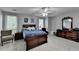 Bedroom features a ceiling fan, windows, and wooden furniture, creating a comfortable and inviting space at 1119 Riverbend Club Se Dr, Atlanta, GA 30339