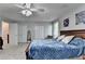 Bedroom with a bed, white closet doors, and a ceiling fan offering comfort and functionality at 1119 Riverbend Club Se Dr, Atlanta, GA 30339