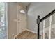 Bright foyer with wood floors, stairs, and a white front door with sidelight window at 1119 Riverbend Club Se Dr, Atlanta, GA 30339
