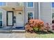 Charming front entrance with a beautiful flower bush and well-maintained landscape at 1119 Riverbend Club Se Dr, Atlanta, GA 30339