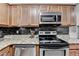 This kitchen boasts stainless steel appliances, including a dishwasher, microwave, and stove at 1119 Riverbend Club Se Dr, Atlanta, GA 30339