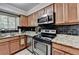 Updated kitchen featuring stainless steel appliances, granite countertops, and ample cabinet space at 1119 Riverbend Club Se Dr, Atlanta, GA 30339
