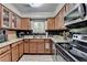 A charming kitchen features granite countertops, wood cabinets, and black tile backsplash at 1119 Riverbend Club Se Dr, Atlanta, GA 30339