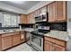 Kitchen features stainless steel appliances, granite countertops, and wood-look flooring at 1119 Riverbend Club Se Dr, Atlanta, GA 30339