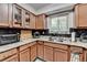 Kitchen featuring granite countertops, wood cabinets, and a stainless steel sink under the window at 1119 Riverbend Club Se Dr, Atlanta, GA 30339