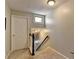 Light and airy stairwell featuring carpeted steps, painted handrail, and access to upper levels at 1119 Riverbend Club Se Dr, Atlanta, GA 30339