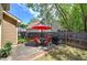 Backyard featuring a patio with red chairs, a grill, lawn and perimeter fence at 2186 Mainsail Dr, Marietta, GA 30062
