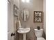 Pedestal sink and decorative wall art in a charming half bathroom at 2186 Mainsail Dr, Marietta, GA 30062