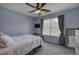 A cozy bedroom features soft blue walls, carpeted floors, and a ceiling fan at 2186 Mainsail Dr, Marietta, GA 30062