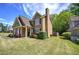 Charming two-story home with a covered front porch, manicured lawn, and professional landscaping at 2186 Mainsail Dr, Marietta, GA 30062