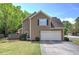 Charming two-story home with a two-car garage, manicured lawn, and professional landscaping at 2186 Mainsail Dr, Marietta, GA 30062