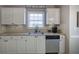 Modern kitchen featuring white cabinets, stainless steel appliances, and stylish fixtures at 2186 Mainsail Dr, Marietta, GA 30062