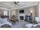 Cozy living room featuring a fireplace, ceiling fan, and comfortable seating arrangement at 2186 Mainsail Dr, Marietta, GA 30062