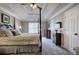 Main bedroom featuring a tray ceiling, four poster bed, and neutral decor at 2186 Mainsail Dr, Marietta, GA 30062
