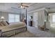 Spacious main bedroom featuring a four-poster bed, tray ceiling, and carpeted floors at 2186 Mainsail Dr, Marietta, GA 30062