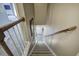 View down carpeted staircase with wooden handrail and a glimpse of the entry at 2186 Mainsail Dr, Marietta, GA 30062