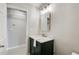 Elegant bathroom with a black vanity, marble countertop and modern gold fixtures at 22 Haygood Se Ave, Atlanta, GA 30315