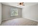 Spacious bedroom with carpet, ceiling fan, and large window for natural light at 22 Haygood Se Ave, Atlanta, GA 30315