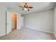 Bright bedroom featuring plush carpet, ceiling fan and a walk-in closet at 22 Haygood Se Ave, Atlanta, GA 30315