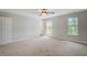 Large carpeted bedroom with two windows and ceiling fan at 22 Haygood Se Ave, Atlanta, GA 30315