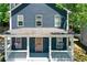 Charming home featuring a covered porch, pink front door, and navy blue siding at 22 Haygood Se Ave, Atlanta, GA 30315