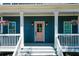 Inviting front porch showcasing hanging flower baskets and a stylish pink door at 22 Haygood Se Ave, Atlanta, GA 30315