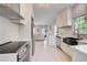 Bright kitchen features stainless appliances, white cabinetry, and a herringbone tile backsplash at 22 Haygood Se Ave, Atlanta, GA 30315
