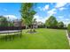 Lush backyard featuring a trampoline, green grass, and fenced perimeter at 416 Battlefield Creek Dr, Marietta, GA 30064